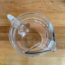 Load image into Gallery viewer, Fantastic vintage mid-century beverage pitcher decorated with a pink basketweave pattern topped with a band of white ivy and ribbed handle. Produced by Federal Glass, circa 1950s. The perfect addition to any style vintage kitchen and your tablescape will thank you! Glassware dreams are made of this beauty! In like new condition, free from chips/wear. The paint is vibrant and shiny. Unmarked. Measures 5 x 8 inches Capacity 90 ounces