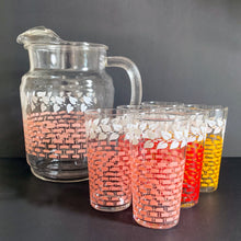 Load image into Gallery viewer, Fantastic vintage mid-century beverage pitcher decorated with a pink basketweave pattern topped with a band of white ivy and ribbed handle. Produced by Federal Glass, circa 1950s. The perfect addition to any style vintage kitchen and your tablescape will thank you! Glassware dreams are made of this beauty! In like new condition, free from chips/wear. The paint is vibrant and shiny. Unmarked. Measures 5 x 8 inches Capacity 90 ounces