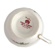 Load image into Gallery viewer, Traditional vintage mid-century era Avon shaped teacup and saucer featuring hand painted pink cabbage roses and heavy gold filigree pattern of flowers on the cup and saucer interiors with gently scalloped gold gilt rims. Crafted by Royal Albert, England, circa 1950s. A beautiful gift or addition to your collection!