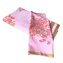 Load image into Gallery viewer, Give your table a touch of elegance with this vintage pink cotton tablecloth featuring flowers in eye-popping salmon with swirls of pale pink, bordered in ochre. With 12 matching napkins. Perfect for adding a hint of sophistication to any gathering! In excellent condition, free from stains/tears Tablecloth measures 56 x 92 inches Napkin measures 16 1/2 x 17 inches