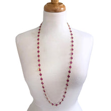 Load image into Gallery viewer, This stunning vintage opera-length necklace, features sparkly dark pink faceted cut crystals set in gold-toned metal, sporting a Swarovski branded tag. Crafted by Swarovski, Austria, 1980s. Wear it long and elegant, doubled for a layered look, or paired with other vintage pieces for effortless glamour. A beautiful example of classic Swarovski craftsmanship, this piece offers luxury sparkle at a fraction of the cost of fine gemstones.
