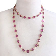 Load image into Gallery viewer, This stunning vintage opera-length necklace, features sparkly dark pink faceted cut crystals set in gold-toned metal, sporting a Swarovski branded tag. Crafted by Swarovski, Austria, 1980s. Wear it long and elegant, doubled for a layered look, or paired with other vintage pieces for effortless glamour. A beautiful example of classic Swarovski craftsmanship, this piece offers luxury sparkle at a fraction of the cost of fine gemstones.
