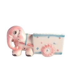 Load image into Gallery viewer, Adorable kitschy pink elephant pulling a wagon nursery planter. Crafted by Rubens Originals, Japan, 1950s. A sweet addition for your new addition. Use for tiny plants or repurpose to hold baby accessories.
In excellent as found vintage condition, no chips/cracks/repairs, normal crazing present.
Measures 6 1/2 x 2 1/2 x 3 1/2 inches