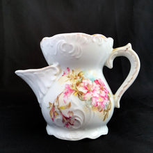Load image into Gallery viewer, Vintage white porcelain mustache cup glazed in a deep coral with gold gilt flowers and rim featuring a sweet gold flower on the handle. Use as intended or repurpose as a toothbrush or make-up brush holder. Made in Germany. In excellent condition, no chips/cracks/repairs. Some wear to the gold. Dimensions: 4" x 3-5/8"