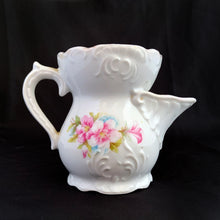Load image into Gallery viewer, Vintage white porcelain mustache cup glazed in a deep coral with gold gilt flowers and rim featuring a sweet gold flower on the handle. Use as intended or repurpose as a toothbrush or make-up brush holder. Made in Germany. In excellent condition, no chips/cracks/repairs. Some wear to the gold. Dimensions: 4" x 3-5/8"