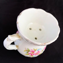 Load image into Gallery viewer, Vintage white porcelain mustache cup glazed in a deep coral with gold gilt flowers and rim featuring a sweet gold flower on the handle. Use as intended or repurpose as a toothbrush or make-up brush holder. Made in Germany. In excellent condition, no chips/cracks/repairs. Some wear to the gold. Dimensions: 4" x 3-5/8"