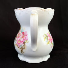 Load image into Gallery viewer, Vintage white porcelain mustache cup glazed in a deep coral with gold gilt flowers and rim featuring a sweet gold flower on the handle. Use as intended or repurpose as a toothbrush or make-up brush holder. Made in Germany. In excellent condition, no chips/cracks/repairs. Some wear to the gold. Dimensions: 4" x 3-5/8"