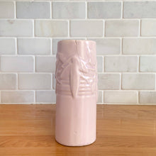 Load image into Gallery viewer, Vintage Art Deco matte pink Castle Gate Butterfly Line vase. Crafted by Nelson McCoy Pottery, early 1940s. This rare piece is must for any art pottery collector!
In as found condition, no chips/repairs, crack on one castle, see photos. Unmarked.
Measures 7 3/8 x 2 1/2 x 6 inches