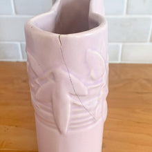 Load image into Gallery viewer, Vintage Art Deco matte pink Castle Gate Butterfly Line vase. Crafted by Nelson McCoy Pottery, early 1940s. This rare piece is must for any art pottery collector!
In as found condition, no chips/repairs, crack on one castle, see photos. Unmarked.
Measures 7 3/8 x 2 1/2 x 6 inches