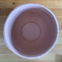 Load image into Gallery viewer, Rare vintage matte pink Sand Butterfly jardiniere planter with embossed vertical bands topped with a border of leaves and butterflies. Crafted by McCoy Pottery, 1930s. This rare planter is must for any McCoy art pottery collector. A wonderful piece to elevate your home and garden decor or to give as a gift!
In as found vintage condition, chips to the rim and crack, no repairs. Normal age-related crazing and manufacturer's glaze pops. Maker's mark on the bottom.
Measures 8 x 7 inches