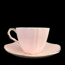 Load image into Gallery viewer, Opposite side profile of vintage EB Foley 1850 scalloped bone china teacup and saucer, pale pink with floral motif and gold gilt