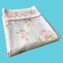 Load image into Gallery viewer, Vintage Truprest pink Rose Romance queen size flat poly/cotton white bed sheet featuring roses in shades of pink and green, trimmed with pink lace at the band. Crafted by Texmade, Canada, 1973-1977. A beautiful addition to your bedding collection, or repurpose for crafts, quilting or garment making.
In excellent vintage condition, no stains or tears, fading. Original label present.
Measures 88 x 106 inches | 224 x 270 centimeters.