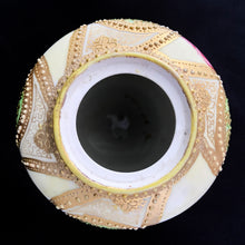 Load image into Gallery viewer, Absolutely exquisite vintage hand painted porcelain lidded ginger jar, crafted by artisans in Japan, late 1800s - early 1900s. It features sweeping panes of pink roses against a yellow and deep teal with alternating peacock feather-like shapes of gold gilt, heavily embellished with moriage, as is the lid. According to Kovels, Nippon Porcelain dates between 1891-1921. After that, US law required imports to be labeled with the country of origin in English. This one-of-a-kind piece.
