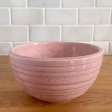 Load image into Gallery viewer, Vintage pink speckled horizontal ribbed ceramic ovenware mixing bowl. Crafted by McCoy Pottery, 1950s. A rare piece to add to your art pottery collection!
In excellent condition, no chips/cracks/repairs. Age-related crazing and wear. Typical manufacturing glaze pops. Maker's marks.
Measures 5 x 2 3/4 inches