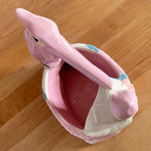 Load image into Gallery viewer, Vintage gloss pink glazed stork nursery ceramic planter with cold painted details. Crafted by McCoy Pottery, 1956. This rare planter is a must-have for any McCoy collector. It makes a wonderful gift for a baby shower and adds a nice touch of whimsy to your baby's nursery decor.
In excellent vintage condition, no chips/cracks/repairs, typical age-related wear to the cold paint. Marked on the bottom.
Measures 7 x 4 1/4 x 7 inches