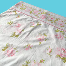 Load image into Gallery viewer, Vintage Truprest pink Rose Romance queen size flat poly/cotton white bed sheet featuring roses in shades of pink and green, trimmed with pink lace at the band. Crafted by Texmade, Canada, 1973-1977. A beautiful addition to your bedding collection, or repurpose for crafts, quilting or garment making.
In vintage condition, no stains or tears. Original label present.
Measures 88 x 106 inches | 224 x 270 centimeters.