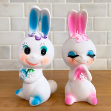 Load image into Gallery viewer, Adorable kitschy pink and blue bunny rabbit couple Bun-Bun chalkware figurines with the sweetest expressions and flower details. Crafted in Taiwan, 1970s. New old stock in original box. Cute doesn't quite capture these sweethearts!
In excellent condition, new in original shipping box.
Measures approximately 2 5/8 x 2 7/8 x 6 3/4 inches