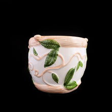Load image into Gallery viewer, This vintage white ceramic planter is decorated with pink and green raised ivy design. Produced by Claire Burke, Taiwan, circa 1970s. In excellent condition, free from chips/cracks/repairs. Marked "Claire Burke Ti" on the bottom with Made in Taiwan sticker. Measures 7 1/4 x 4 3/8 x 3 1/2 inches