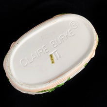 Load image into Gallery viewer, This vintage white ceramic planter is decorated with pink and green raised ivy design. Produced by Claire Burke, Taiwan, circa 1970s. In excellent condition, free from chips/cracks/repairs. Marked "Claire Burke Ti" on the bottom with Made in Taiwan sticker. Measures 7 1/4 x 4 3/8 x 3 1/2 inches