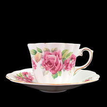 Load image into Gallery viewer, This vintage bone china scalloped shaped teacup and saucer featuring pink roses and gold gilt details. Crafted by Royal Stuart, England, 1948 - 1960. A lovely way to enjoy a cuppa tea.
In excellent condition, no chips, cracks or repairs. Maker's mark on the bottom.
Teacup measures 3 1/2 x 2 3/4 inches | Saucer measures 5 7/8 inches