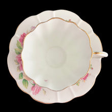 Load image into Gallery viewer, This vintage bone china scalloped shaped teacup and saucer featuring pink roses and gold gilt details. Crafted by Royal Stuart, England, 1948 - 1960. A lovely way to enjoy a cuppa tea.
In excellent condition, no chips, cracks or repairs. Maker's mark on the bottom.
Teacup measures 3 1/2 x 2 3/4 inches | Saucer measures 5 7/8 inches