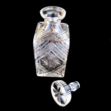 Load image into Gallery viewer, Introduce elegance and sophistication to your bar with this elegant heavy-weighted vintage cut lead crystal "Pinwheel" glass liquor decanter. The intricate design and expert craftsmanship will impress any liquor connoisseur and add a touch of sparkle to your barware collection. In excellent condition, free from chips. Tiny minor scuff on the underside of the stopper. Measures 3 5/8 x 3 5/8 x 9 1/2 inches