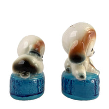 Load image into Gallery viewer, Vintage puppy dogs on blue poofs ceramic salt and pepper shakers with plastic stoppers. Imported by Giftcraft. Japan 1960s. Add these adorable and highly collectible shakers to your collection!
In excellent vintage condition, no chips/cracks/repairs. Giftcraft sticker on one shaker, otherwise unmarked.
Measures 2 x 1 3/4 x 3 1/4 inches