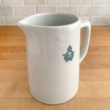 Load image into Gallery viewer, Vintage vitrified stoneware pottery handled pitcher, embossed with the RCAF King’s Tudor logo. Crafted by Medalta Pottery, Canada, 1950s. A nice piece of utilitarian pottery made for the Royal Canadian Air Force.
In excellent condition, no chips/cracks.
Measures 3 7/8 x 5 1/4 inches