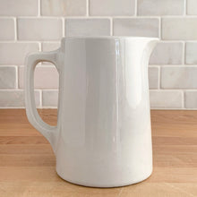 Load image into Gallery viewer, Vintage vitrified stoneware pottery handled pitcher, embossed with the RCAF King’s Tudor logo. Crafted by Medalta Pottery, Canada, 1950s. A nice piece of utilitarian pottery made for the Royal Canadian Air Force.
In excellent condition, no chips/cracks.
Measures 3 7/8 x 5 1/4 inches