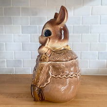 Load image into Gallery viewer, Adorable vintage, mid-century era anthropomorphic ceramic rabbit cookie jar. Crafted by Royal Sealy, Japan, 1950s. A delightful addition to your cookie jar collection and kitchen decor!
In as found vintage condition, with 2 chips to the rim of the lid and a well executed repair to one ear, see photos. No cracks and typical age-related crazing.
Measures 6 x 7 1/4 x 13 1/4 inches