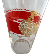 Load image into Gallery viewer, Fabulous vintage art deco rooster-themed cocktail shaker featuring a wide red enamel band bordered on either side with a scalloped band and a large gold rooster. The tapered glass cocktail shaker is finished with a round shoulder and topped off with a silver plate dome lid, crafted by the Derby-Shelton Silver Company, 1930s. This shaker is truly something to crow about!
In used vintage condition, no chips, wear to the gold in the shoulder band.
Measures 4 1/2 x 10 7/8 inches
