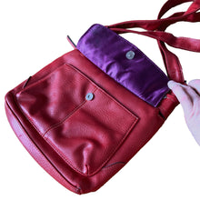 Load image into Gallery viewer, Vintage red faux leather crossbody purse, featuring zippered closure, adjustable strap, snap and zippered exterior pockets, purple interior with one zippered, two open pockets. Crafted by Emilie M.
In excellent vintage condition, see photos.
Measurements with strap 9 x 35 inches
Measurements without strap 9 x 9 3/4 inches