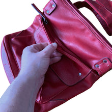 Load image into Gallery viewer, Vintage red faux leather crossbody purse, featuring zippered closure, adjustable strap, snap and zippered exterior pockets, purple interior with one zippered, two open pockets. Crafted by Emilie M.
In excellent vintage condition, see photos.
Measurements with strap 9 x 35 inches
Measurements without strap 9 x 9 3/4 inches