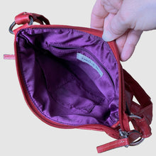 Load image into Gallery viewer, Vintage red faux leather crossbody purse, featuring zippered closure, adjustable strap, snap and zippered exterior pockets, purple interior with one zippered, two open pockets. Crafted by Emilie M.
In excellent vintage condition, see photos.
Measurements with strap 9 x 35 inches
Measurements without strap 9 x 9 3/4 inches