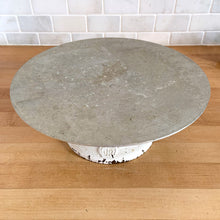 Load image into Gallery viewer, Vintage revolving cake decorating stand featuring a solid cast iron base and aluminum turntable. The base is painted off white and embossed with the initials JR inside a crown. Crafted by J. R. Mahoney for Crown Cookware, USA, 1930s. Perfect to use as intended, or to display cakes, baked good or use to create a special display of your favourite vintage treasures. A wonderful accessory for a vintage kitchen with a vintage or farmhouse theme or old fashioned bakery.
Vintage condition. 12 x 4 1/2 inches
