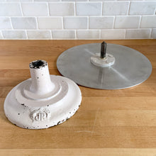 Load image into Gallery viewer, Vintage revolving cake decorating stand featuring a solid cast iron base and aluminum turntable. The base is painted in a putty colour and embossed with the initials JR inside a crown. Crafted by J. R. Mahoney for Crown Cookware, USA, 1930s. Perfect to use as intended, or to display cakes, baked good or use to create a special display of your favourite vintage treasures. A wonderful accessory for a vintage kitchen with a vintage or farmhouse theme or old fashioned bakery.
Vintage condition 12 x 4 1/2 inch