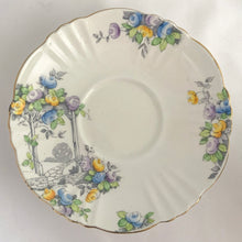 Load image into Gallery viewer, Vintage art deco white bone china teacup and saucer is absolutely gorgeous! Produced by Royal Albert, England, circa 1927 - 1935. Decorated in the "Rosalie" pattern which depicts a hand painted garden path featuring a trellis filled with blue, purple and yellow flowers, trimmed with gold gilt. Excellent condition, free from chips, cracks and repairs. Maker's marks are on the bottom. Teacup measures 3 3/8 x 2 3/4 inches | Saucer measures 5 1/4 inches