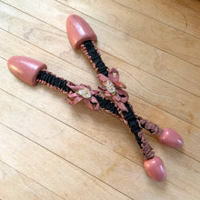 Load image into Gallery viewer, Vintage ladies wood and metal shoe stretchers in rose pink with pretty black and rose fabric covers. These feature wood ends between a flexible metal strap. Perfect to help your shoes retain their original shape. Circa 1950s In good vintage condition with minor age-related wear. Measures approximately 11 1/2 inches long