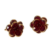 Load image into Gallery viewer, Front view of vintage Swarovski ruby red crystal flower clip-on earrings showing precision-cut facets and brilliant sparkle in gold-tone settings