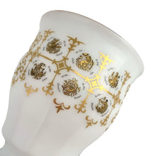Load image into Gallery viewer, Unusual vintage milk glass goblet bearing the signs of the zodiac horoscope, featuring two medallions with the symbol and dates of the "Sagittarius" sign in both English and German. Graphics of the remaining zodiac signs appear on the sides of the gold rimmed goblet. Crafted in Germany.