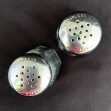 Load image into Gallery viewer, Vintage clear pressed glass paneled salt and pepper shakers with stainless steel lids. Crafted by Dominion Glass, Canada, 1950s. Classic tableware that's always in style!
The glass is in excellent condition, no chips, minor wear to the lids.
Measures 1 3/8 x 3 inches