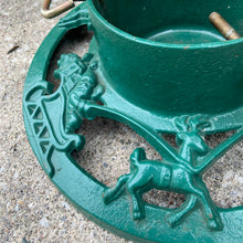 Load image into Gallery viewer, Get ready to put up the Christmas tree using this gorgeous cast iron stand in hunter green, decorated with Santa Claus in his sleigh with reindeer! The perfect addition to your vintage or modern Christmas decor.
In used vintage condition.
Dimensions: 14 inch diameter, reservoir measures 6 1/4 x 4 1/4 inches
