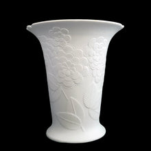 Load image into Gallery viewer, Vintage Sardinia white bisque flower footed trumpet vase features an embossed bouquet of flowers and semi-scalloped rim. Marked 642. Designed by M. Frey for Kaiser, Germany, 1980s. This delicate vase will look stunning in any setting!
In excellent condition, no chips/cracks/repairs. Maker's mark on bottom.
Measures 5 5/8 x 5 3/4 x 6 1/4 inches