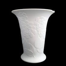 Load image into Gallery viewer, Vintage Sardinia white bisque flower footed trumpet vase features an embossed bouquet of flowers and semi-scalloped rim. Marked 642. Designed by M. Frey for Kaiser, Germany, 1980s. This delicate vase will look stunning in any setting!
In excellent condition, no chips/cracks/repairs. Maker's mark on bottom.
Measures 5 5/8 x 5 3/4 x 6 1/4 inches