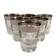 Load image into Gallery viewer, Close-up of the silver metallic rim on the clear mid-century shot glass.