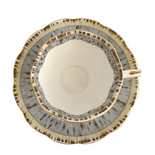 Load image into Gallery viewer, Vintage "Silver Birch" porcelain teacup and saucer. Crafted by Royal Albert, England, 1935 - 1945. This beautiful pattern consists of lakeside woodland scene of birch trees and colourful flowers surrounded with a border of rustic gray and cream, rimmed in gold gilt. In excellent condition, free from chips/cracks/repairs.