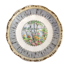 Load image into Gallery viewer, Vintage "Silver Birch" porcelain teacup and saucer. Crafted by Royal Albert, England, 1935 - 1945. This beautiful pattern consists of lakeside woodland scene of birch trees and colourful flowers surrounded with a border of rustic gray and cream, rimmed in gold gilt. In excellent condition, free from chips/cracks/repairs.