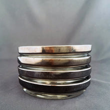 Load image into Gallery viewer, Detail of the four stackable silver fade glass coasters with textured bottoms.