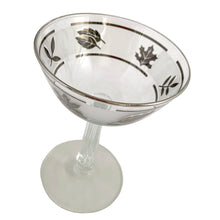 Load image into Gallery viewer, Set of six vintage mid-century Silver Leaf champagne or tall sherbet glasses featuring silver leaves set on a frosted band bordered by silver bands and a grecian column stem. Crafted by Libbey Glass, USA, 1953 - 1978. These put the glam in glamourous and will make a stunning addition to your barware collection!
In excellent condition, free form chips/cracks/wear.
Measures 3 3/4 x 5 5/8 inches