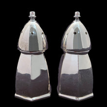 Load image into Gallery viewer, Experience the luxurious beauty of these vintage silver plate salt and pepper shakers, crafted in a classic hexagonal shape with a domed top. Created by Benedict-Proctor Manufacturing Co. in Canada during the 1920s, these shakers have been expertly polished to reveal their stunning resemblance to the 'Bishop' chess piece. Elevate your tablescape with their regal and shining presence! In excellent vintage condition. Each shaker measures 1 1/4 x 2 3/4 inches